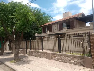 a black fence in front of a house at Departamento Matrimonial Merlo San luis in Merlo