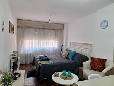 a bedroom with a bed and a couch and a table at El Abrojal 4 - Monoambiente Céntrico, zona Patio Olmos in Cordoba