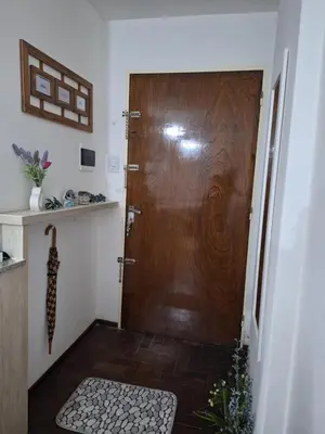 a large wooden door in a room with a floor at El Abrojal 4 - Monoambiente Céntrico, zona Patio Olmos in Cordoba