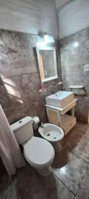 a bathroom with a toilet and a sink at Cabaña Don Leonardo in Santa Rosa de Calamuchita