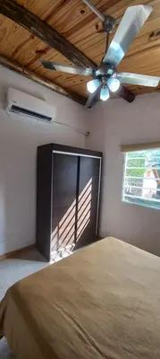 a bedroom with a bed and a ceiling fan at Cabaña Don Leonardo in Santa Rosa de Calamuchita