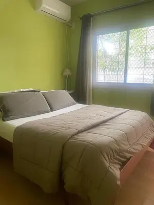 a large bed in a bedroom with a window at Jardín del norte a mts de sanatorio Allende, Hospital Privado cerro,Nascentis y estadio Kempes in Cordoba