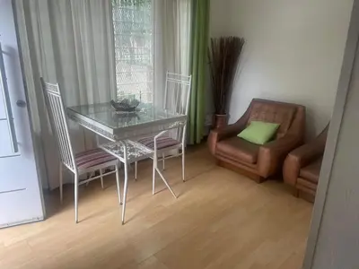 a dining room with a glass table and chairs at Jardín del norte a mts de sanatorio Allende, Hospital Privado cerro,Nascentis y estadio Kempes in Cordoba