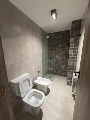 a bathroom with a toilet and a sink at Departamento moderno pleno centro con pileta y cochera privada in Villa Carlos Paz
