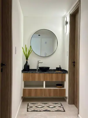 a bathroom with a sink and a mirror at Departamento moderno pleno centro con pileta y cochera privada in Villa Carlos Paz