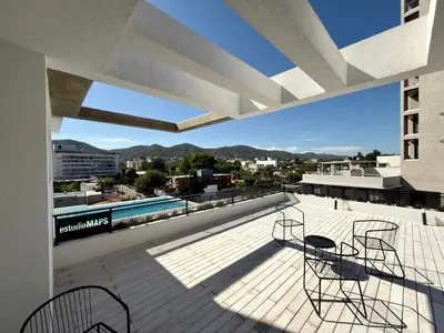 a balcony with chairs and a view of the city at Departamento moderno pleno centro con pileta y cochera privada in Villa Carlos Paz