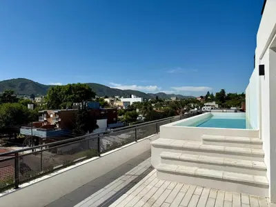 a view from the balcony of a house with a swimming pool at Departamento moderno pleno centro con pileta y cochera privada in Villa Carlos Paz
