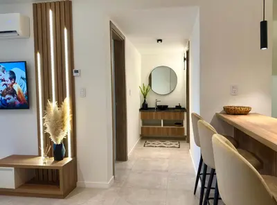 a kitchen and dining room with a table and chairs at Departamento moderno pleno centro con pileta y cochera privada in Villa Carlos Paz