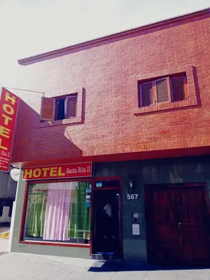 a red brick building with a hotel sign on it at santa rita 2 in Cordoba