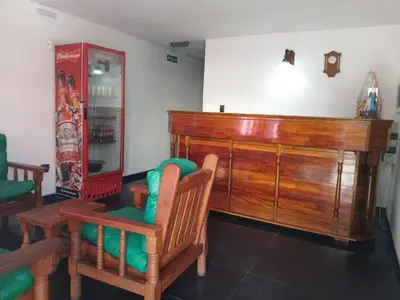a room with a large wooden cabinet and two chairs at santa rita 2 in Cordoba