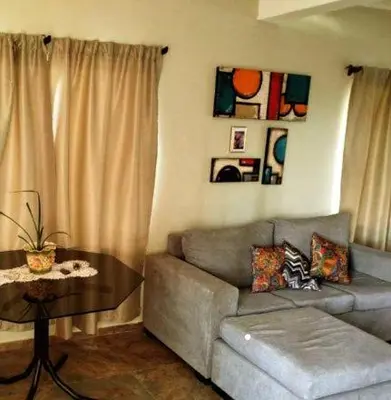 a living room with a couch and a table at Flor silvestre in Carpintería
