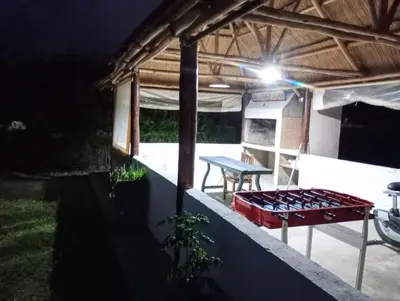a patio with a table and a picnic table on a porch at Flor silvestre in Carpintería