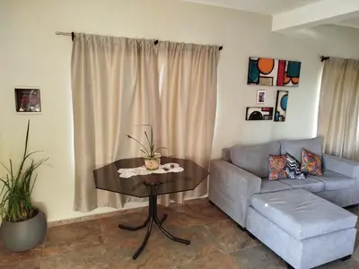 a living room with a couch and a table at Flor silvestre in Carpintería