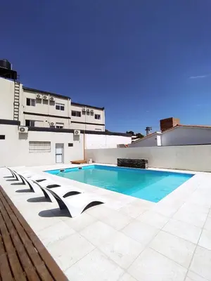 a swimming pool on the roof of a building at Astoria Hotel in Villa Carlos Paz