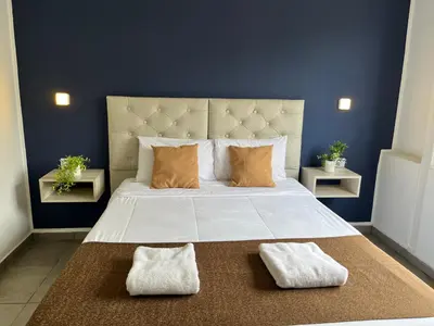 a bedroom with a large bed with two pillows at Astoria Hotel in Villa Carlos Paz