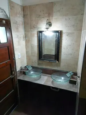 a bathroom with two sinks and a mirror at Rincon de la Selva in La Calera
