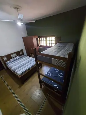 two beds in a room with green walls at Rincon de la Selva in La Calera
