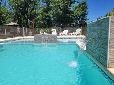 a swimming pool with a fountain in the middle at Cabaña premium! in Villa Anizacate