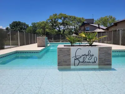 a swimming pool with a sign in the middle of it at Cabaña premium! in Villa Anizacate