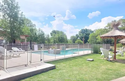 a swimming pool with chairs and a gazebo at Cabaña premium! in Villa Anizacate