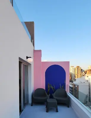 a balcony with two chairs and a table at Pent House Nueva Córdoba in Cordoba