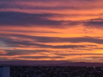 a view of a city at sunset at Pent House Nueva Córdoba in Cordoba
