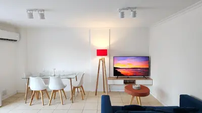 a living room with a tv and a table at Pent House Nueva Córdoba in Cordoba