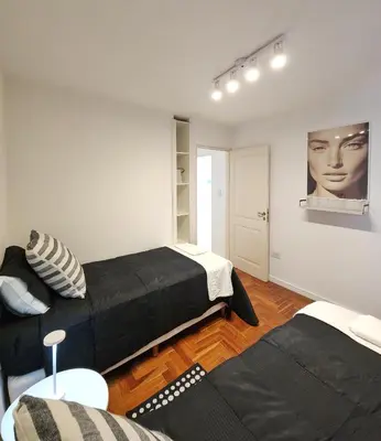 a bedroom with two beds and a couch at Pent House Nueva Córdoba in Cordoba