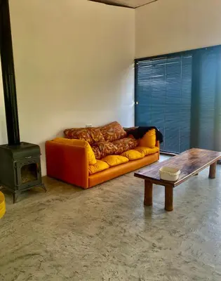 a living room with a couch and a wood stove at Monte Adentro in Dique Nivelador
