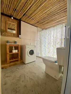a bathroom with a washing machine and a toilet at Monte Adentro in Dique Nivelador