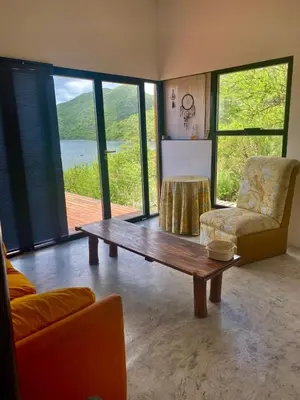a living room with a coffee table and a chair at Monte Adentro in Dique Nivelador