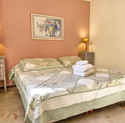 a bedroom with a bed with towels on it at Posada La Lucía in Villa General Belgrano