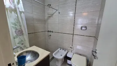 a bathroom with a sink and a toilet and a shower at Departamento pleno centro Carlos Paz con pileta in Villa Carlos Paz