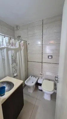a bathroom with a toilet and a bidet and a sink at Departamento pleno centro Carlos Paz con pileta in Villa Carlos Paz