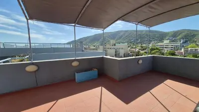 a balcony with a view of a city at Departamento pleno centro Carlos Paz con pileta in Villa Carlos Paz