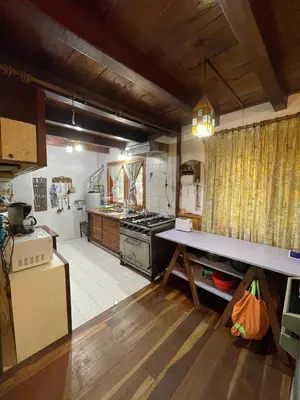 a large kitchen with a stove and a counter top at Casa Familiar in La Cumbrecita
