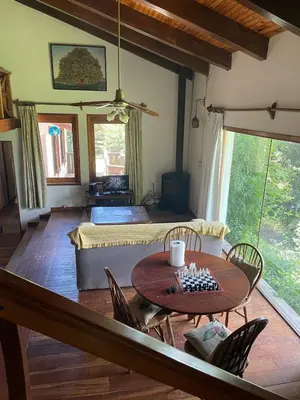 a living room with a table and a couch at Casa Familiar in La Cumbrecita