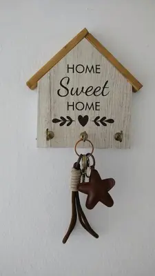 a home sweet home keychain hanging on a wall at Grivia in Cordoba