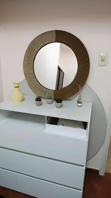 a mirror sitting on top of a white dresser at Grivia in Cordoba