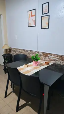 a black table with a potted plant on top of it at Grivia in Cordoba