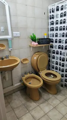 a bathroom with two toilets and a sink at Grivia in Cordoba