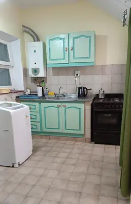 a kitchen with blue cabinets and a stove at Grivia in Cordoba