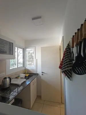 a kitchen with a white refrigerator and a counter at Departamento moderno y luminoso in Cordoba
