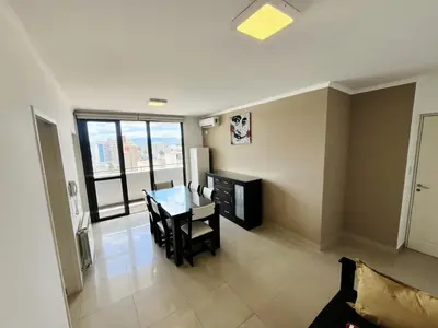 a living room with a table and chairs in a room at Victoria Tower Category Department in Villa Carlos Paz