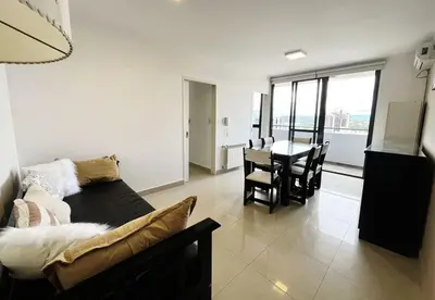 a living room with a couch and a table with chairs at Victoria Tower Category Department in Villa Carlos Paz