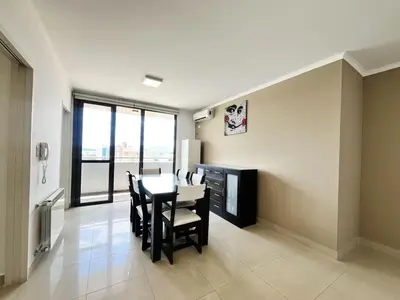 a dining room with a table and chairs and a television at Victoria Tower Category Department in Villa Carlos Paz