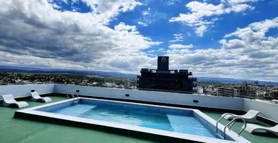 a swimming pool on the roof of a building at Victoria Tower Category Department in Villa Carlos Paz