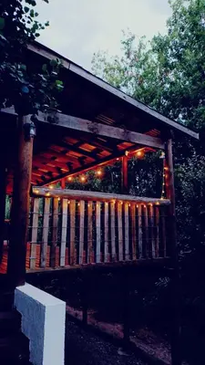 a wooden fence with christmas lights on it at Cabaña El Bordoneo in Villa Yacanto