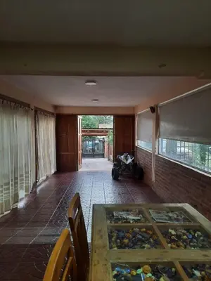 a room with a glass table and a brick wall at Rincón Serrano in Villa Carlos Paz