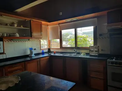 a kitchen with a sink and a window at Rincón Serrano in Villa Carlos Paz